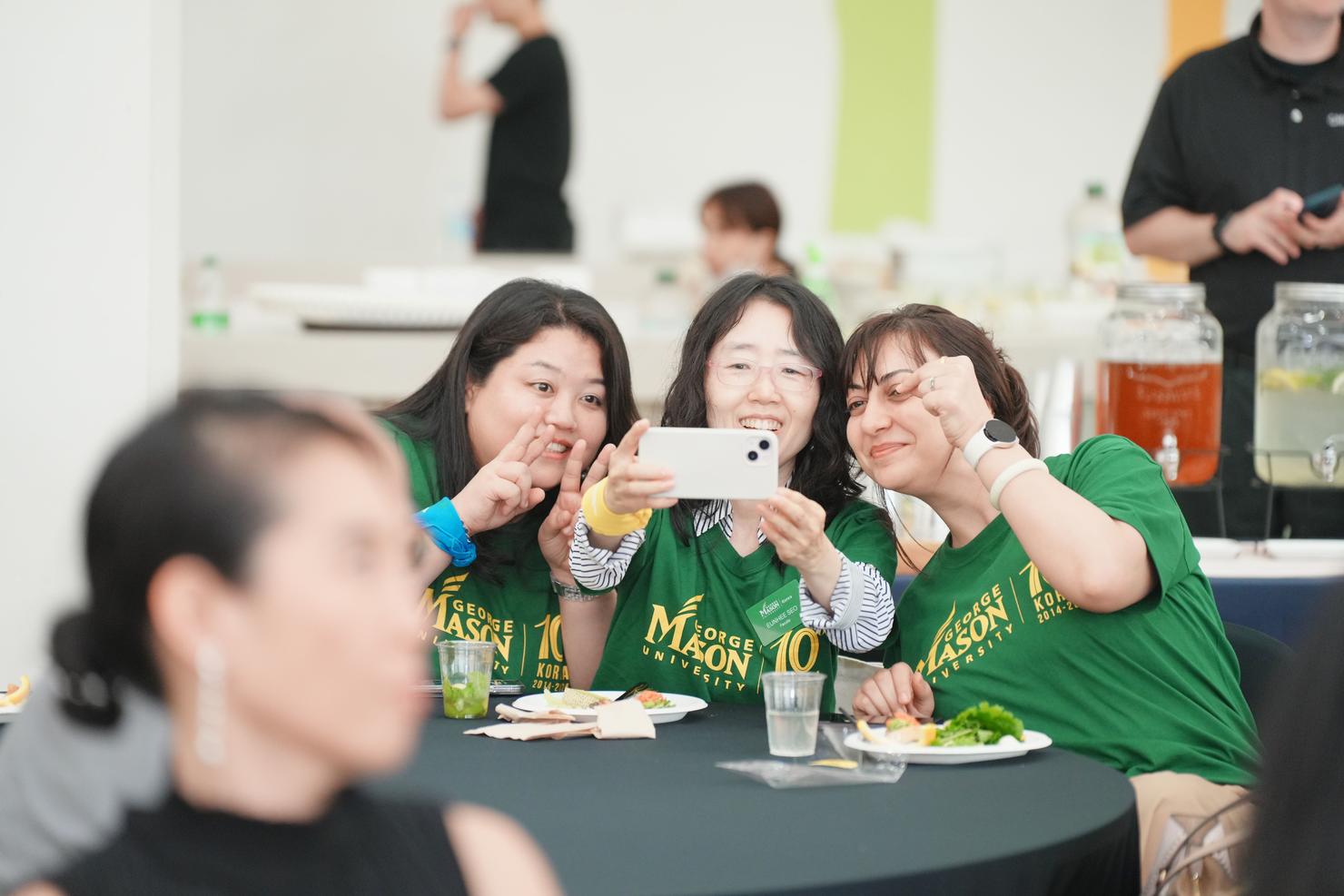 Attendees take a selfie at the Mason Korea celebration